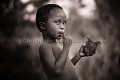 Bushman child eating meat