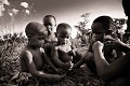 Bushmen child eating meat