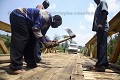 Charpentier employe par le gouvernement pour reparer un pont en bois. Région du lac Kivu, Rwanda.
 Afrique 
 charpentier 
 route 
 réparer 
 pont 
 bois 
 Kivu 
 chaleur 
 circuler 
 piste 
 Africa 
 carpenter 
 road 
 worker 
 bridge 
 wood 
 wooden 
 heat 