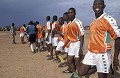 Spécial Coupe du Monde 2006 en Allemagne.
La Photo : Finale "Coupe de la Girafe" au Niger. La petite histoire de cette photo :
Equipe de foot au Niger lors d'une finale de la "Coupe de la Girafe" organisée pour sensibiliser les habitants de la région à la conservation des Girafes blanches du Niger.
La coupe n'a jamais été remise, car la finale s'est soldée par une course poursuite contre l'arbitre suite à un litige... Parti en courant en brousse poursuivit par les joueurs et les supporters en furie des deux villages, on a pas eu de nouvelles de l' arbitre pendant quasiment une semaine ! ...
Il faut dire que le litige provenait d'un ballon qui était passé par dessus la barre transversale et non rentré dans les buts en lobant le gardien.
Pourquoi un tel litige ? Parce que le gardien, voyant qu'il allait être dépassé par le ballon, à tiré sur la corde qui faisait office de barre transversale entre deux perches plantées dans le sable, et a ainsi fait passé le ballon au-dessus des buts... Sacrilège évidemment.
Je crois que je n'ai jamais autant rigolé de toute ma vie ! 
C'est pour ça que l'Afrique me passionne... Même le foot y est extraordinaire... ! :o) Niger 
 ballon 
 foot 
 équipe 
 coupe 
 Girafe 
 Sahel 
 sport 
 couleur 
 Afrique 