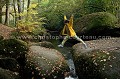 Fillette jouant, sautant par dessus les rochers du chaos granitique du Huelguat à l'automne.
Forêt Domaniale du Huelguat, Finistère, Bretagne. arbre 
 automne 
 bois 
 fall 
 fillette 
 forest 
 forestier 
 foret 
 France 
 habitat 
 jaune 
 jeux 
 jump 
 massif 
 natural 
 nature 
 naturel 
 play 
 river 
 rivie`re 
 sauter 
 tree 
 vegetation 
 wild 
 wilderness 
 wood 
 yellow,
chaos,
boulders,
granit,
granite,
 