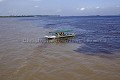 Manaus : Bateau de touristes à l'endroit de la la rencontre des eaux du Rio Negro (eaux sombres à droite et froides à droite, pH acide) et des eaux du Rio Solimoes (eaux chaudes chargées d'argile en jaune à gauche , pH neutre).
Les deux Rivières ne se mélangent pas immédiatement en raison de leurs différentes vitesses d'écoulement, densité, température et acidité.

Manaus : Visitors on boat at the "Meeting of the Waters" : a mix  between the Rio Negro (dark  cool water on the right hand side, ph  7) and the yellow water of the Rio Solimoes (yellow  warm Water on the Left Hand Side, ph = 7). 
The two Rivers don't mix because of two different Velocity, Density, Temperature and acidity (pH).
Nearby Manaus 20 km. 

Amazonie. Manaus, état de l'Amazonas. Brésil.
Amazonia, Manaus, Amazonas State. Brazil. 
 eau 
 rivière 
 fleuve 
 Rio 
 negro 
 Amazone 
 Manaus 
 Amazonie 
 Brésil 
 rencontre 
 Solimoes 
 Water 
 river 
 Rio 
 Negro 
 Amazonas 
 Amazon 
 Brazil 
 Manaus 
 meeting  