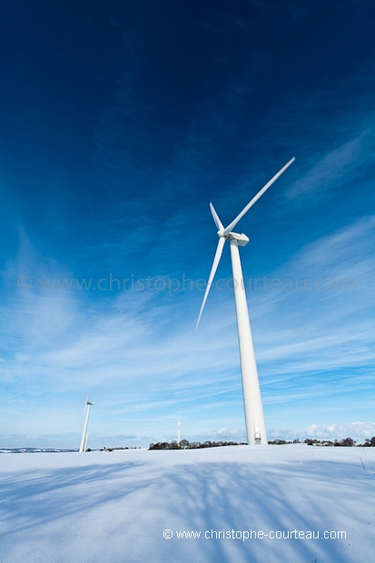 Wind Mills in field under the snow.