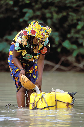 Woman collecting non-drinking water from water hole